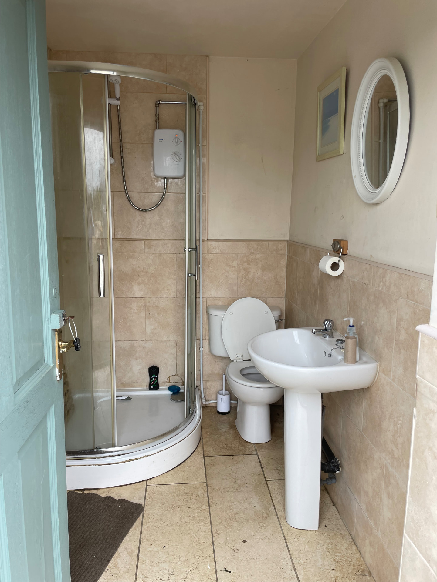 Shower room with an electric shower cubicle, toilet and wash basin